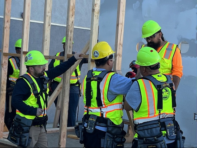 Contruction trainees framing a wall