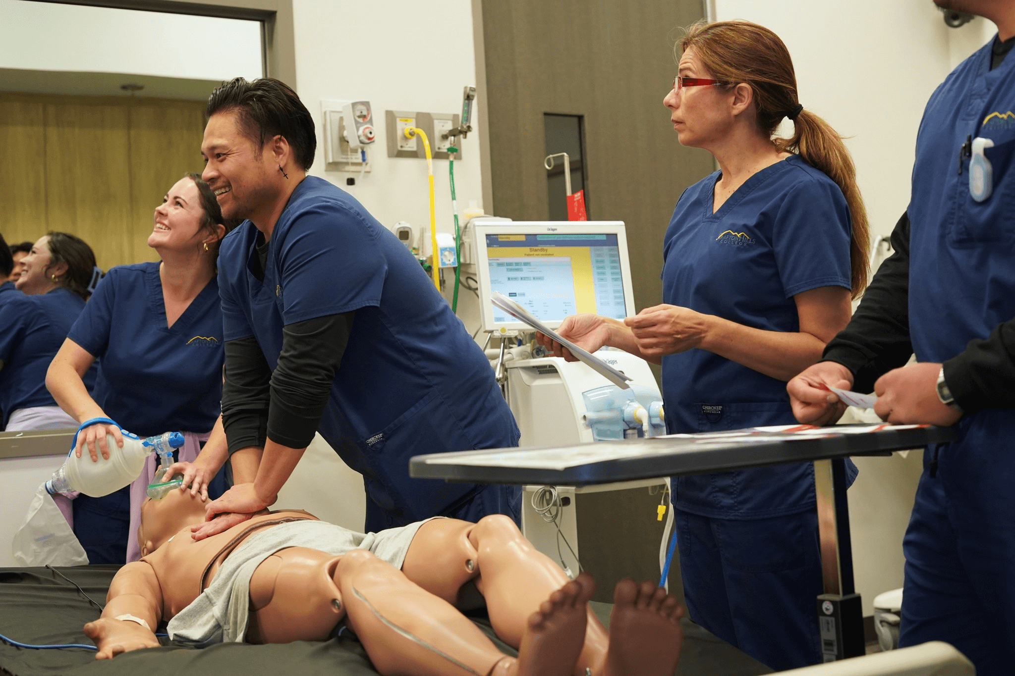 Crafton Hills College nursing students practicing CPR on a dummy.