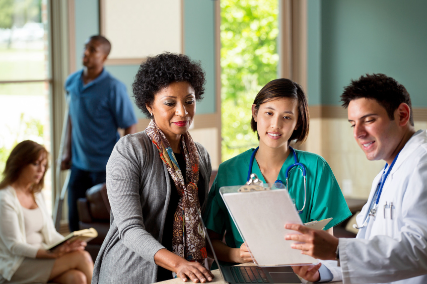 Healthcare professionals discussing with patient.